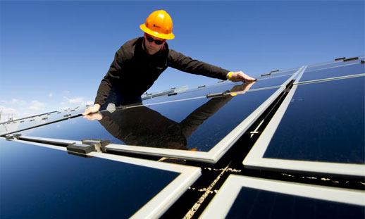 A person is working on a solar panel outside.