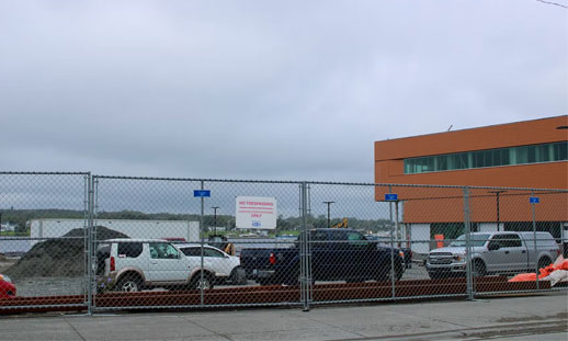 Image shows a parking lot outside a new campus building.
