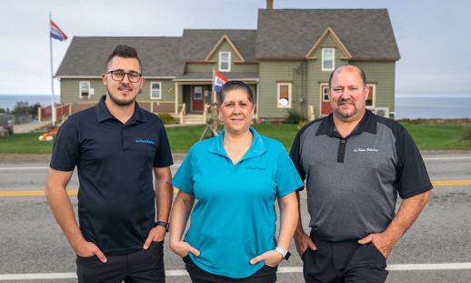 Shane, Nadine & Scott Robicheau standing across the road, in front of their business La Cuisine Robicheau.