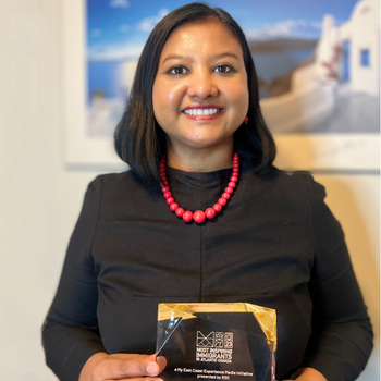 Jubanti holding her Most Inspiring Immigrants in Atlantic Canada award.