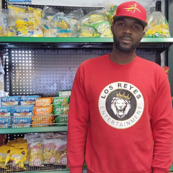 Shawn Montique standing in front a store display.