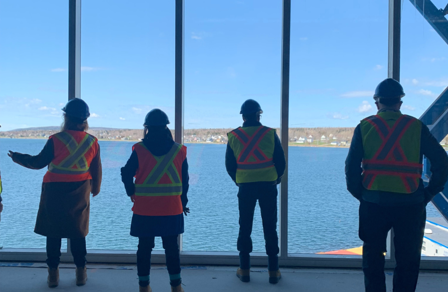 Photo from community engagement tour in Sydney Waterfront Campus pedway with waterfront view.