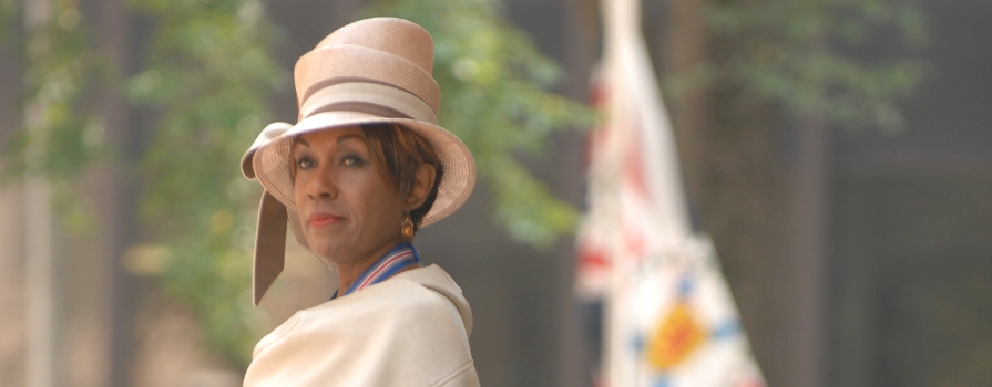 Photo of The Honourable Dr. Mayann E. Francis, in her suit that's displayed at Sydney Waterfront Campus's new interpretative display of Dr. Francis.