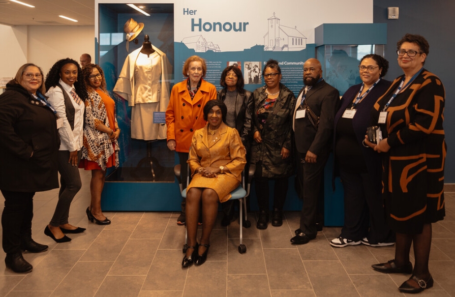 Group photo of Dr. Francis with friends and family in front of her interpretative display at unveiling event.