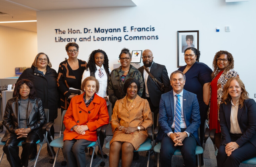 Group photo of Dr. Francis with friends, family and NSCC's Carla Arsenault and Don Bureaux in front of The Hon. Dr. Mayann E. Francis Library and Learning Commons at unveiling event.