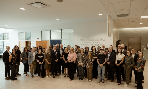 Photo from Office Interiors and RICOH celebration event with their employees and NSCC employees and students in front of the Office Interiors and RICOH Graphic and Print Production Centre at Ivany Campus.