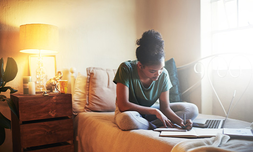 A person sitting on a couch using a computer.