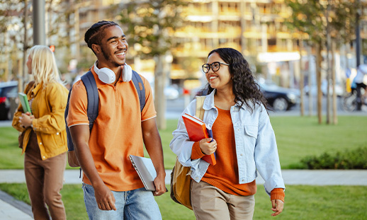 Two students walking together outside.