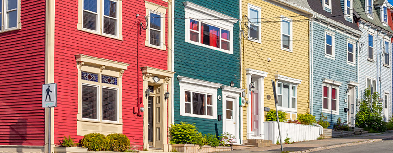 A row of colourful attached houses.