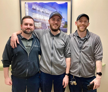 A portrait of three Crombie employees standing together. They are Cory Fraser, Eric Nicholson, Ryan Roberts.