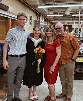 NSCC graduate Mollie posts for a photo with her parents and brother on her graduation day.