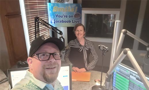 Radio host and guest post for a photo in studio.