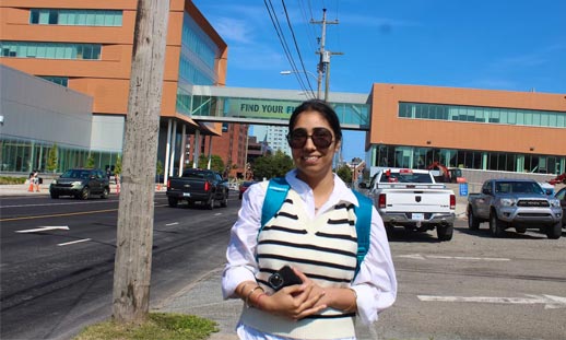 A student stands outside NSCC's new Sydney Waterfront Campus.