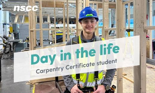 Ethan, a Carpentry Certificate student, stands in front of a wooden frame structure, wearing a hard had and safety gear,