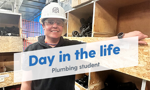 Reese standing in in the plumbing supplies room smiling and looking at the camera