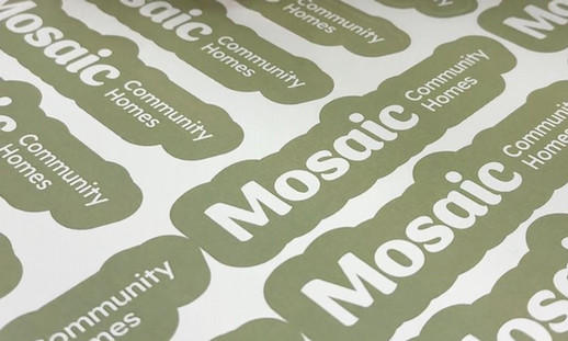 Green stickers are shown that say 'Mosaic Community Homes.'
