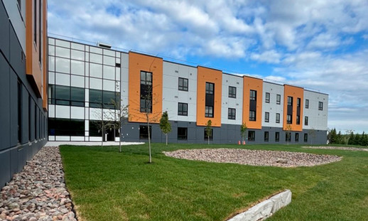 Image shows the outside of NSCC's Akerley Campus student housing and its fresh landscaping.