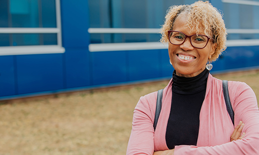 A portrait of a student smiling toward the camera at an NSCC campus.